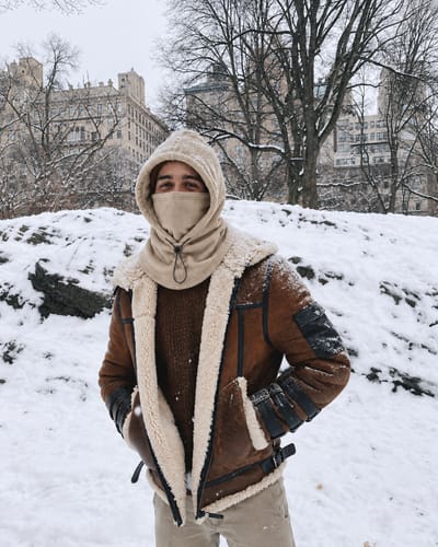 Customer wearing beige winter hood in snow